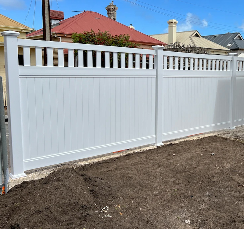 Newly built PVC East Hampton style fence on residential property.