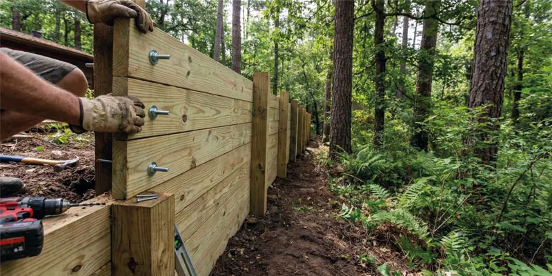 Newly built timber sleeper retaining wall on residential property.