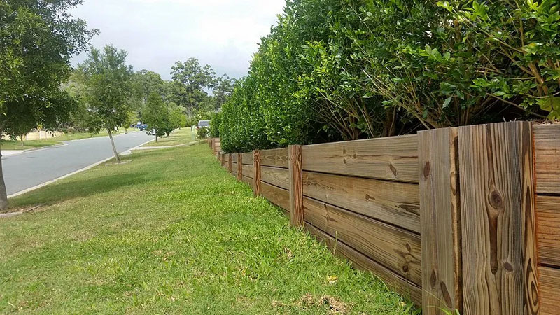 Newly built timber sleeper retaining wall on residential property.