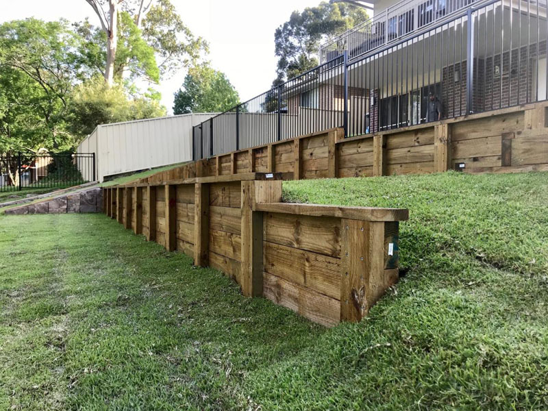 Newly built timber sleeper retaining wall on residential property.