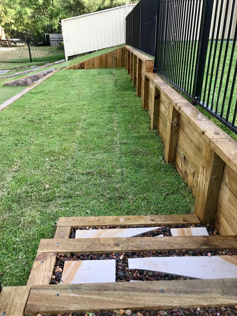 Newly built timber sleeper retaining wall on residential property.