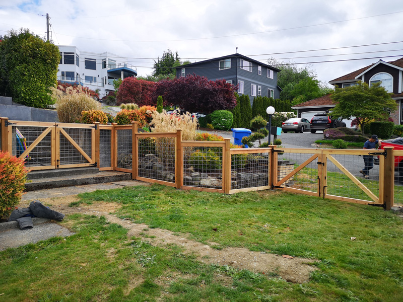 Newly built Colorbond fence with exposed timber posts on residential property.