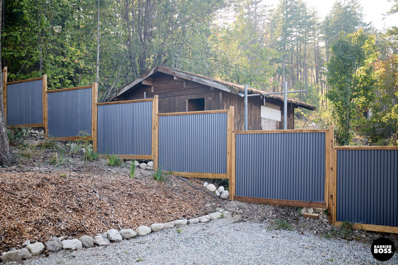 Newly built Colorbond fence with exposed timber posts on residential property.