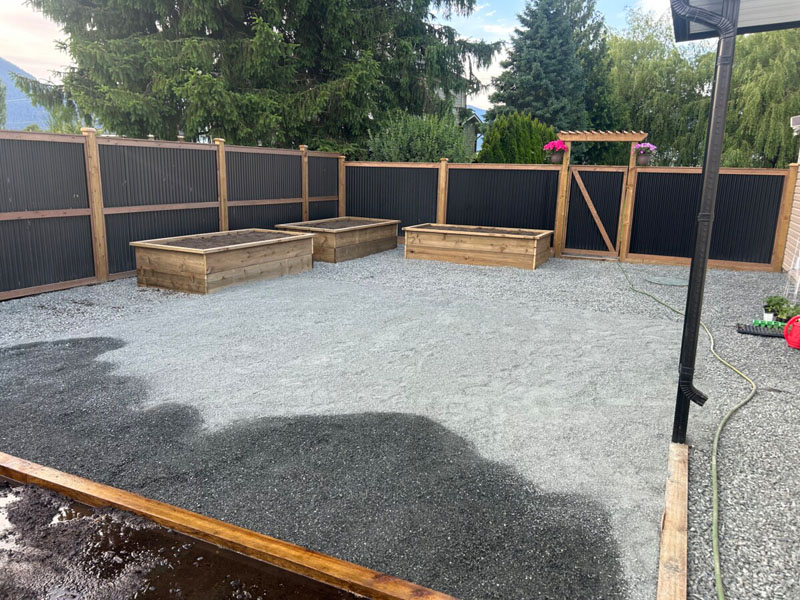Newly built Colorbond fence with exposed timber posts on residential property.