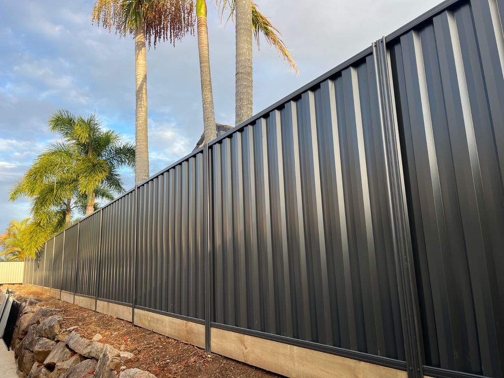 Newly built timber paling fence with lattice on top on residential property.