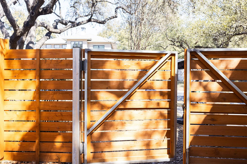 Newly built Colorbond fence with exposed timber posts on residential property.