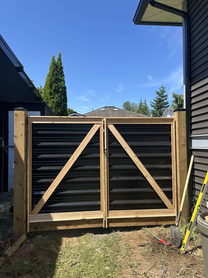 Newly built Colorbond Gate with exposed timber posts on residential property.