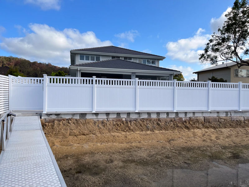 Newly built PVC Hampton style fence on residential property.