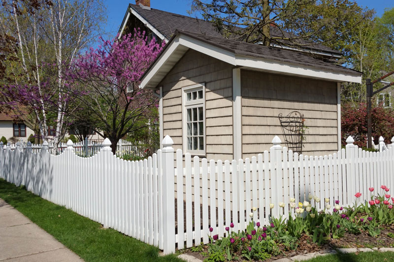 Newly built PVC picket fence on residential property.