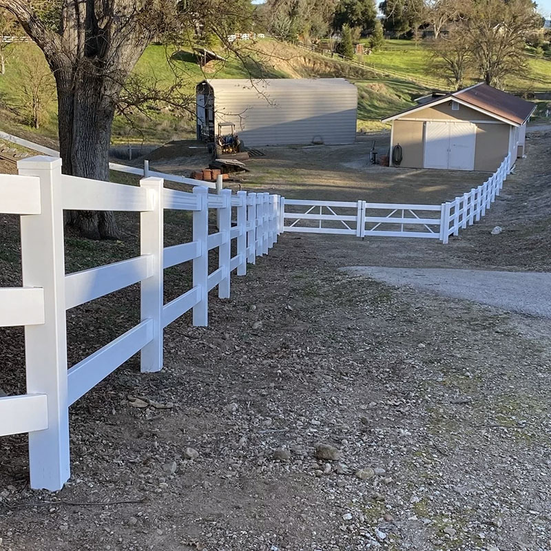 Newly built PVC picket fence on residential property.