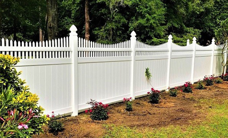 Newly built PVC picket fence on residential property.