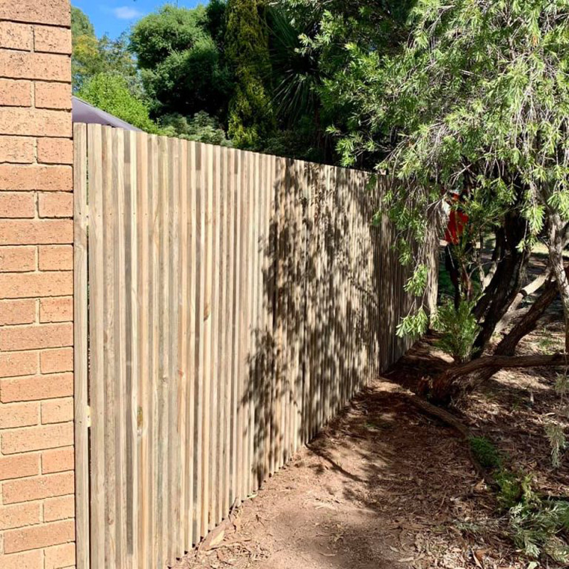 Newly built timber sleeper retaining wall on residential property.