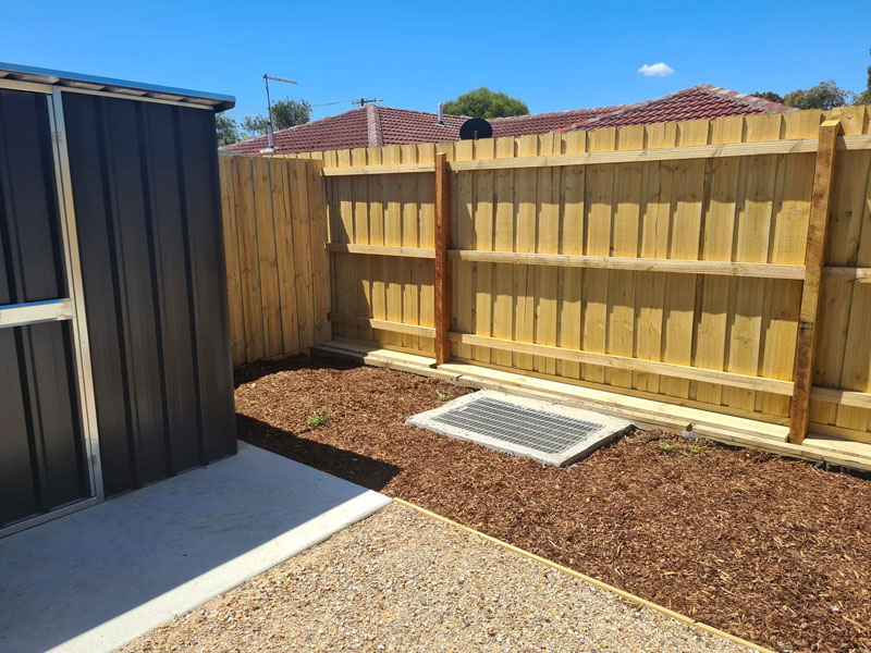 Newly built timber paling fence on residential property.