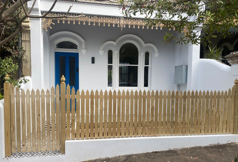 Newly built PVC picket fence on residential property.