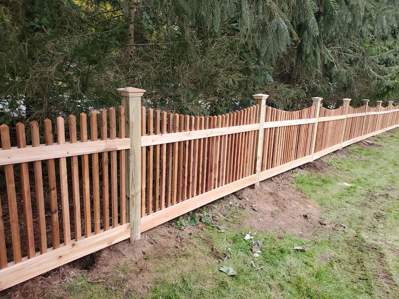 Newly built Colorbond fence with exposed timber posts on residential property.
