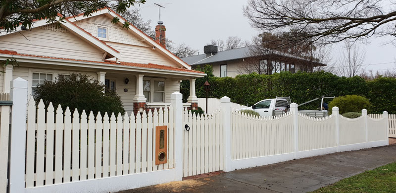 Newly built Colorbond fence with exposed timber posts on residential property.