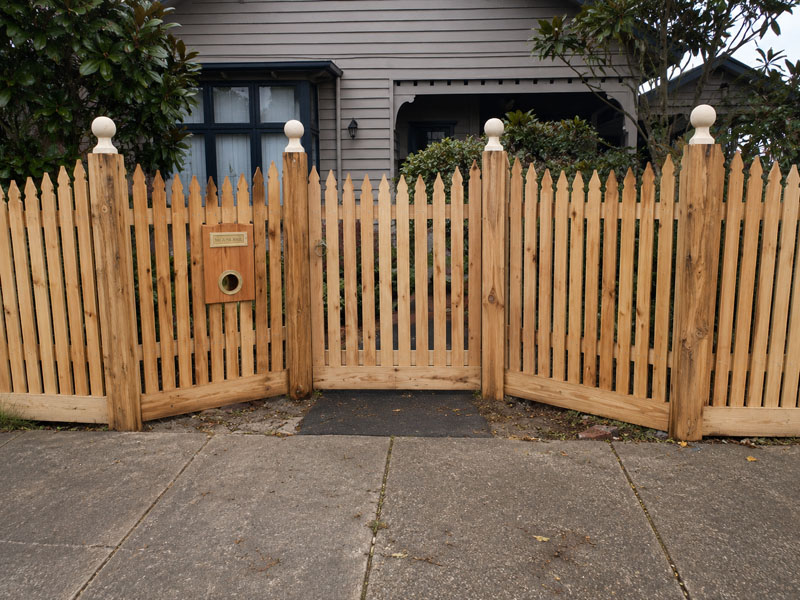 Newly built traditional timber picket fence on residential property.
