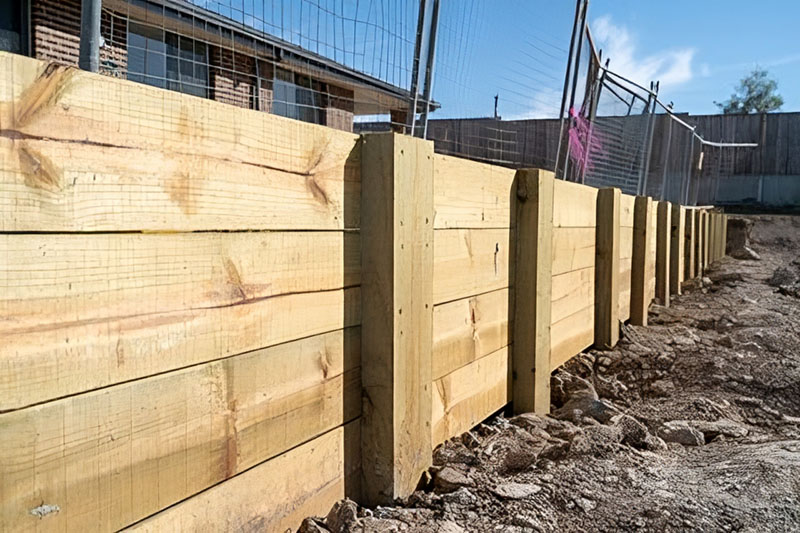 Newly built timber sleeper retaining wall on residential property.